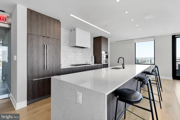 a kitchen with stainless steel appliances a refrigerator and a table