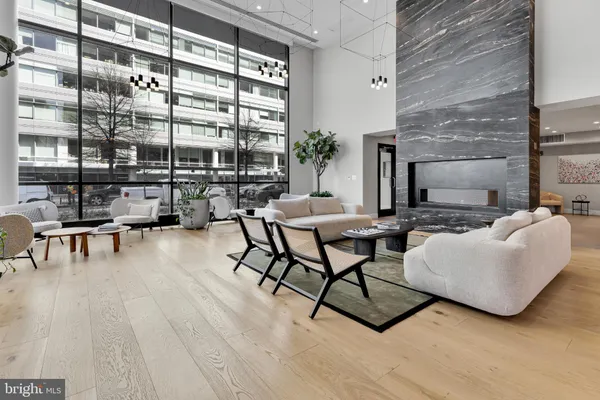 a living room with furniture and a floor to ceiling window