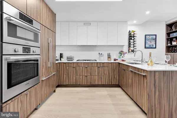 a kitchen with a sink stove and cabinets