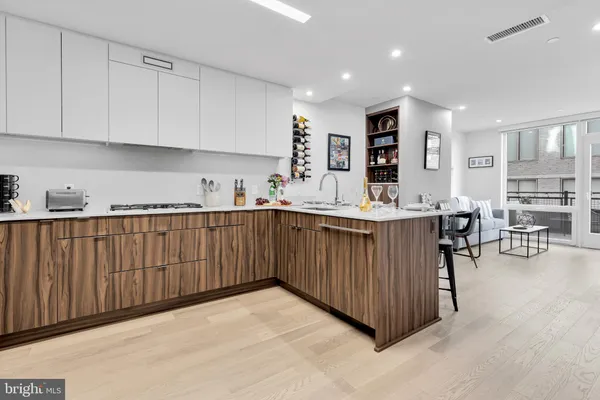 a kitchen with stainless steel appliances sink refrigerator and cabinets