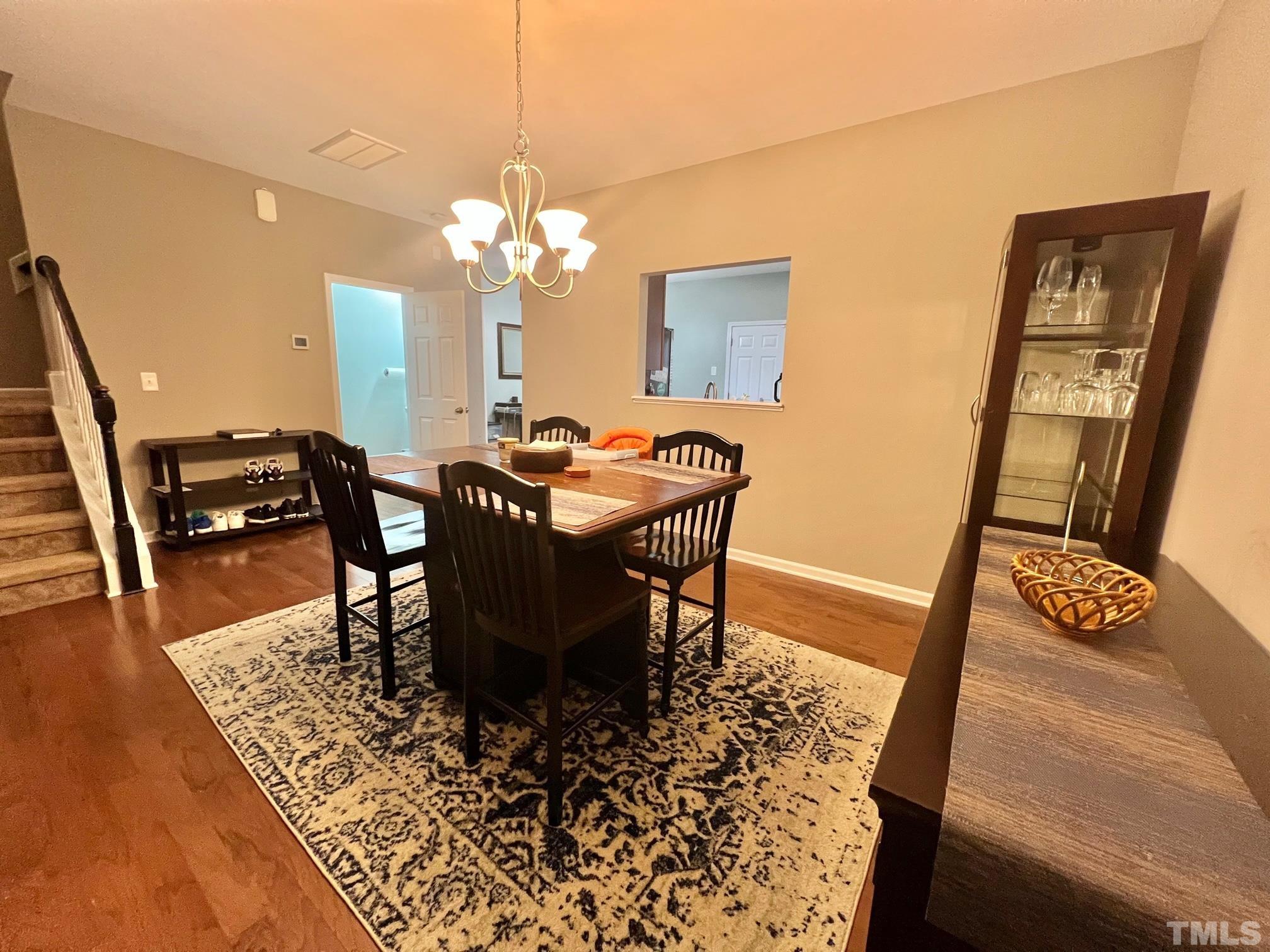 1338 Regulator Street Raleigh, NC 27603 - Photo 6 of 21 a view of a dining room with furniture and wooden floor