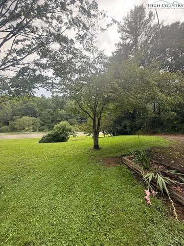 a view of house with backyard space and garden