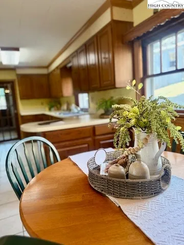a living room with stainless steel appliances kitchen island granite countertop furniture and a wooden floor