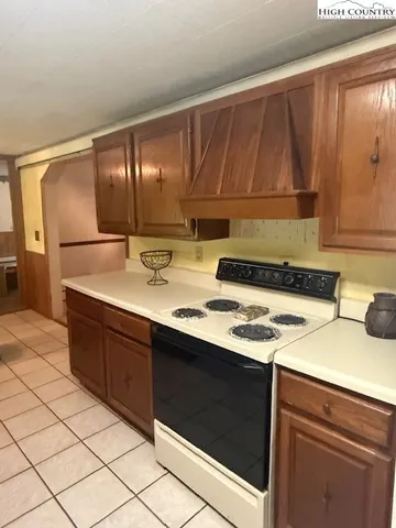 a kitchen with a sink and a stove top oven
