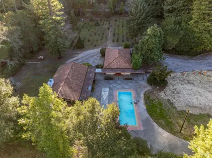 an aerial view of a house with a yard