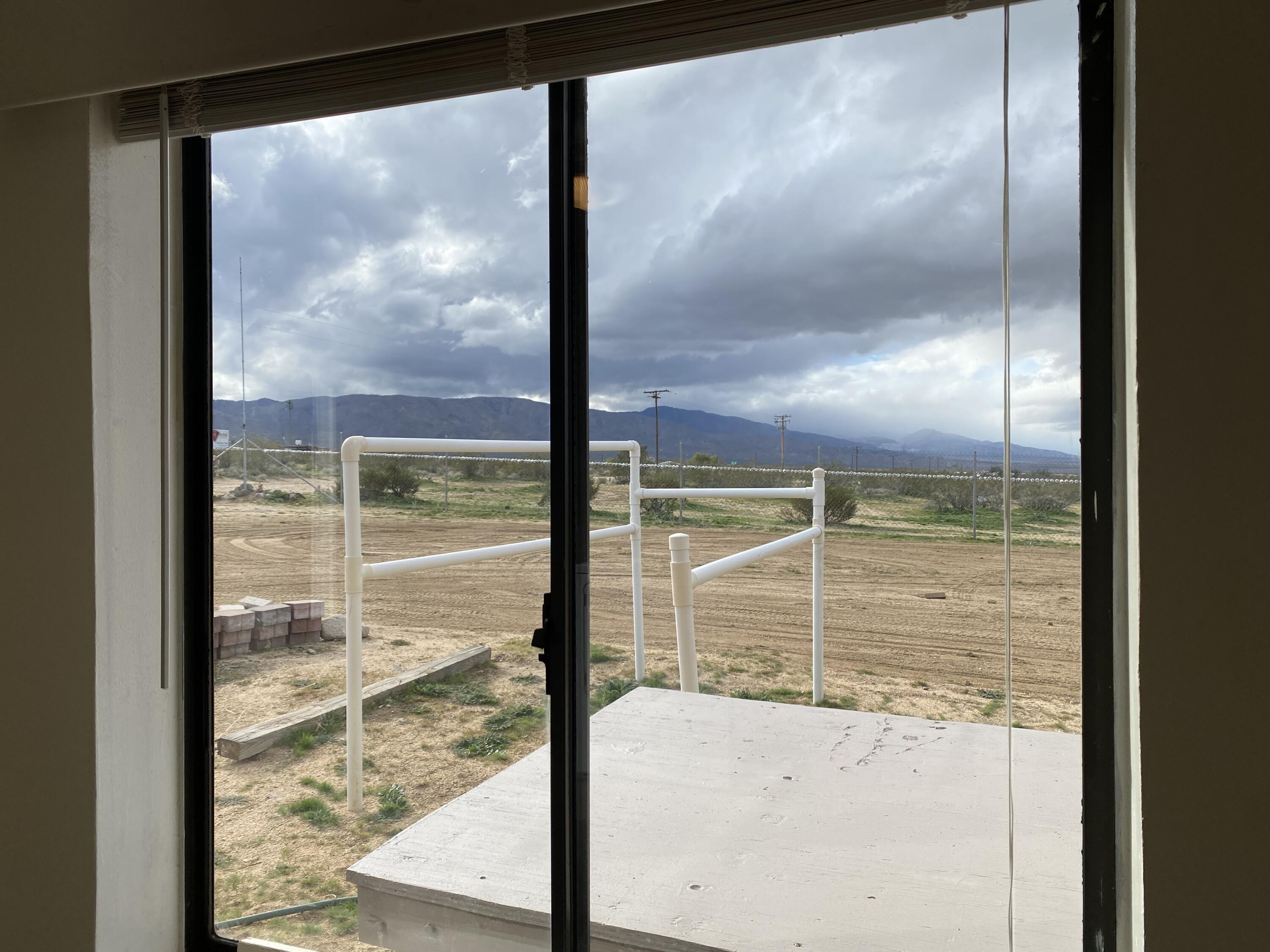 52020 Joshua Tree Road Johnson Valley, CA 92285 - Photo 32 of 48 a view of a glass door with a from a window