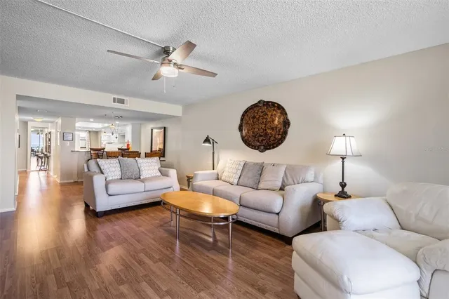 a living room with fireplace furniture and a wooden floor