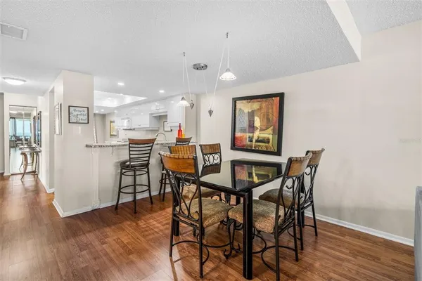 a view of a dining room with furniture and wooden floor