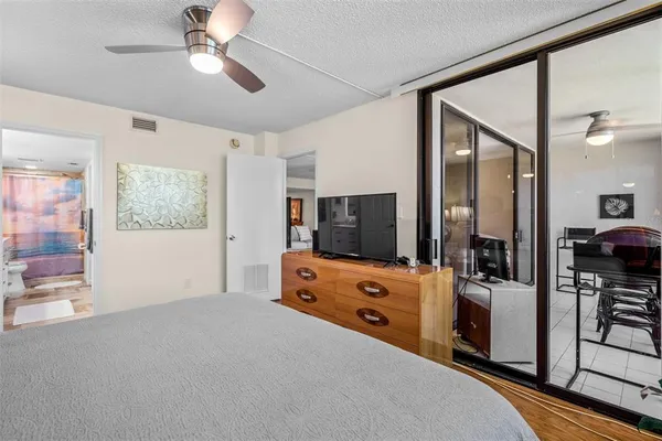 a bedroom with furniture and flat screen tv