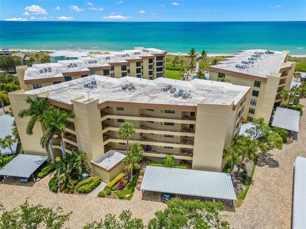 a view of a terrace with wooden floor and a ocean view