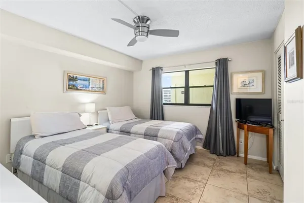 a bedroom with two beds and a window