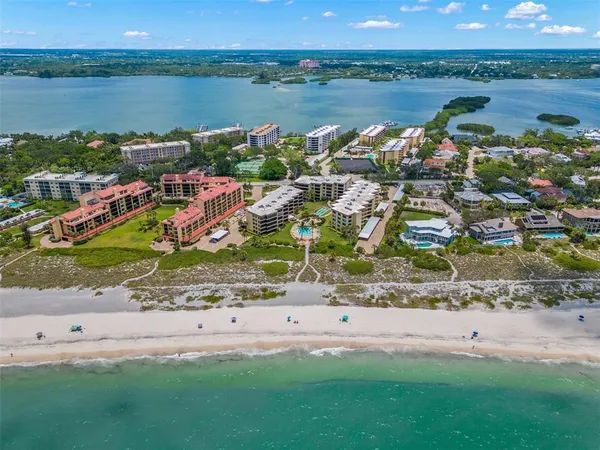 a kitchen with stainless steel appliances kitchen island granite countertop a refrigerator and a sink