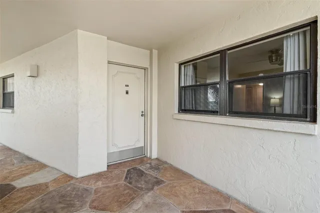 a view of an empty room with closet and windows