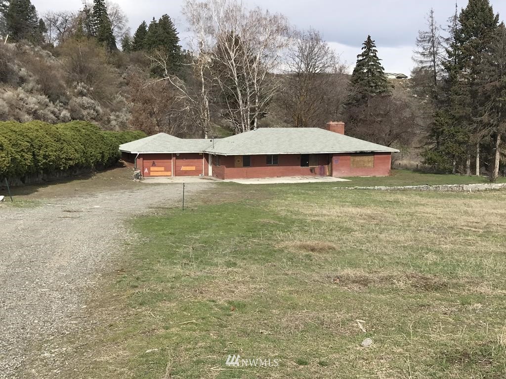 183 Nichols Road Omak, WA 98841 - Photo 1 of 4 a view of a house with a yard and basketball court