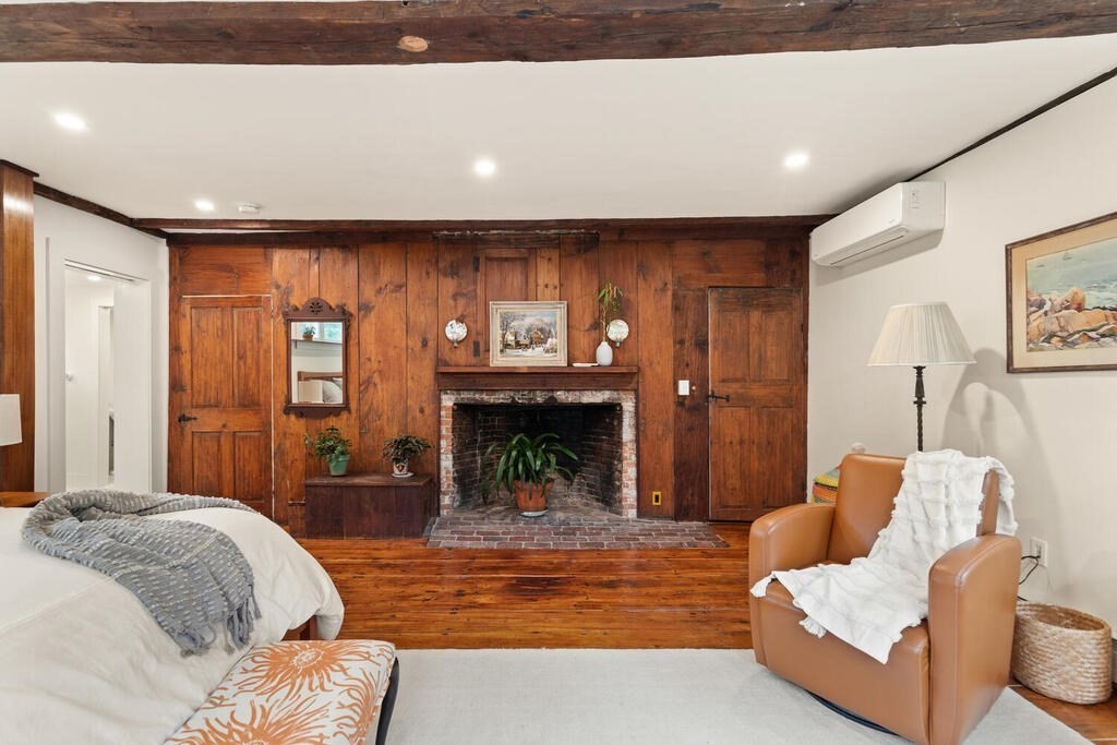 6 Lawrence Road Boxford, MA 01921 - Photo 11 of 42 a bed room with a bed and a fireplace