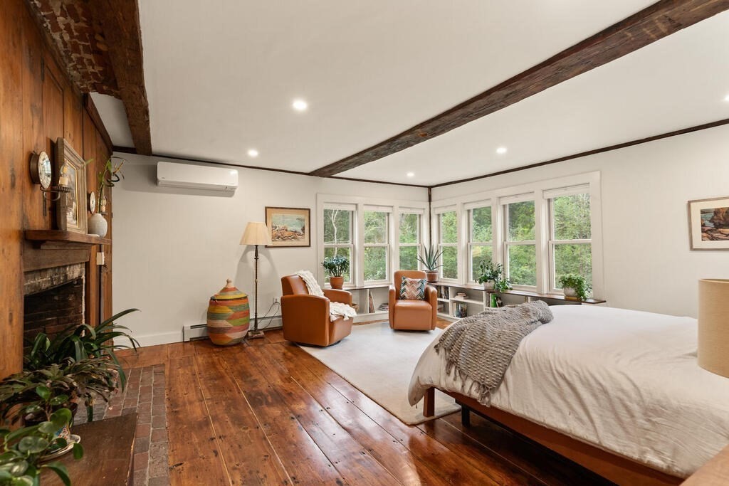 6 Lawrence Road Boxford, MA 01921 - Photo 12 of 42 a spacious bedroom with a bed couch and a large window