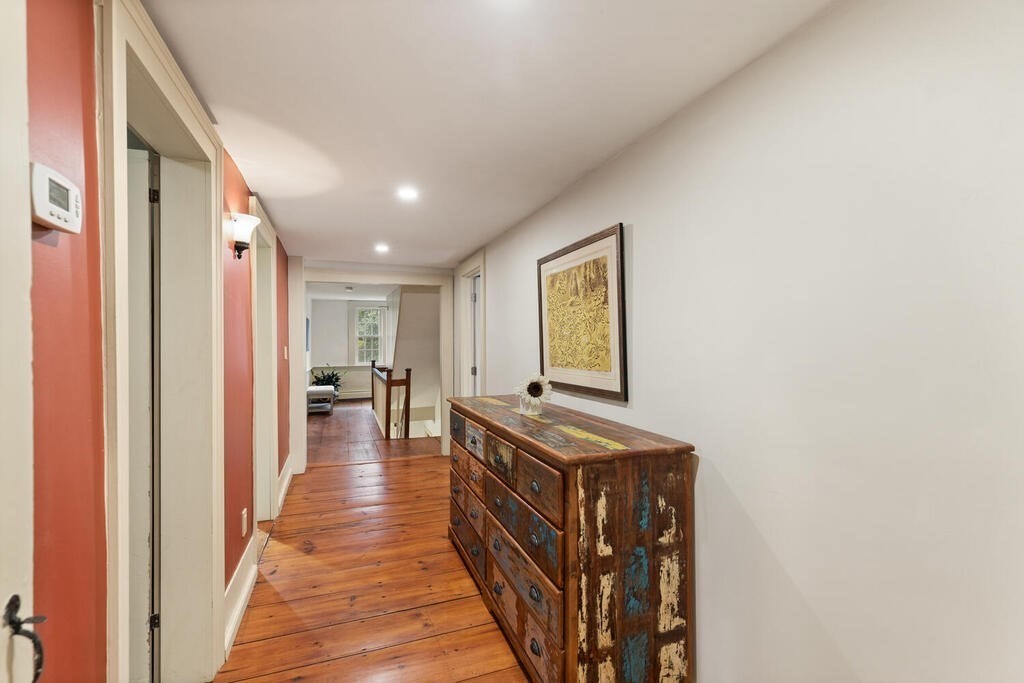 6 Lawrence Road Boxford, MA 01921 - Photo 21 of 42 a view of a hallway with wooden floor and staircase