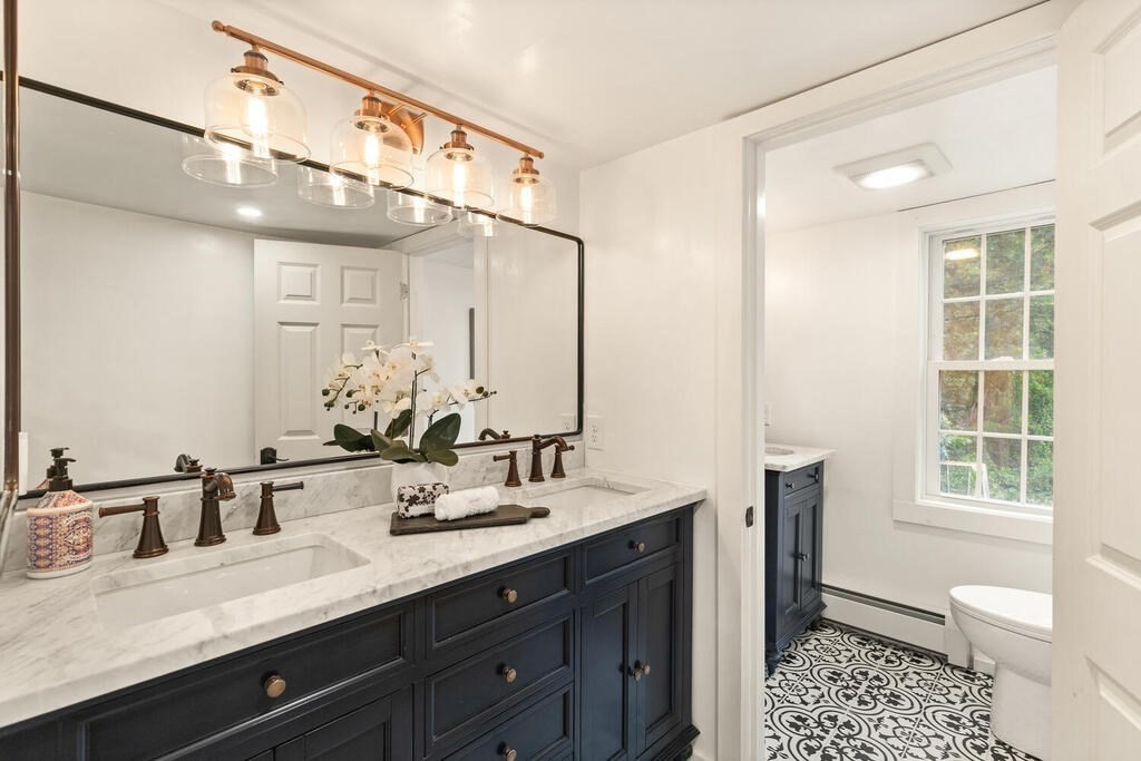 6 Lawrence Road Boxford, MA 01921 - Photo 26 of 42 a bathroom with a sink a large mirror and a toilet