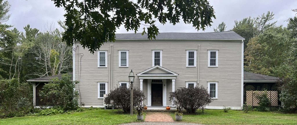 6 Lawrence Road Boxford, MA 01921 - Photo 41 of 42 a view of a white house next to a yard with big trees