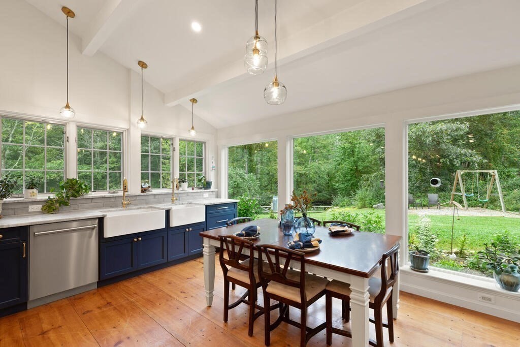 6 Lawrence Road Boxford, MA 01921 - Photo 6 of 42 a view of a dining room with furniture large windows and wooden floor