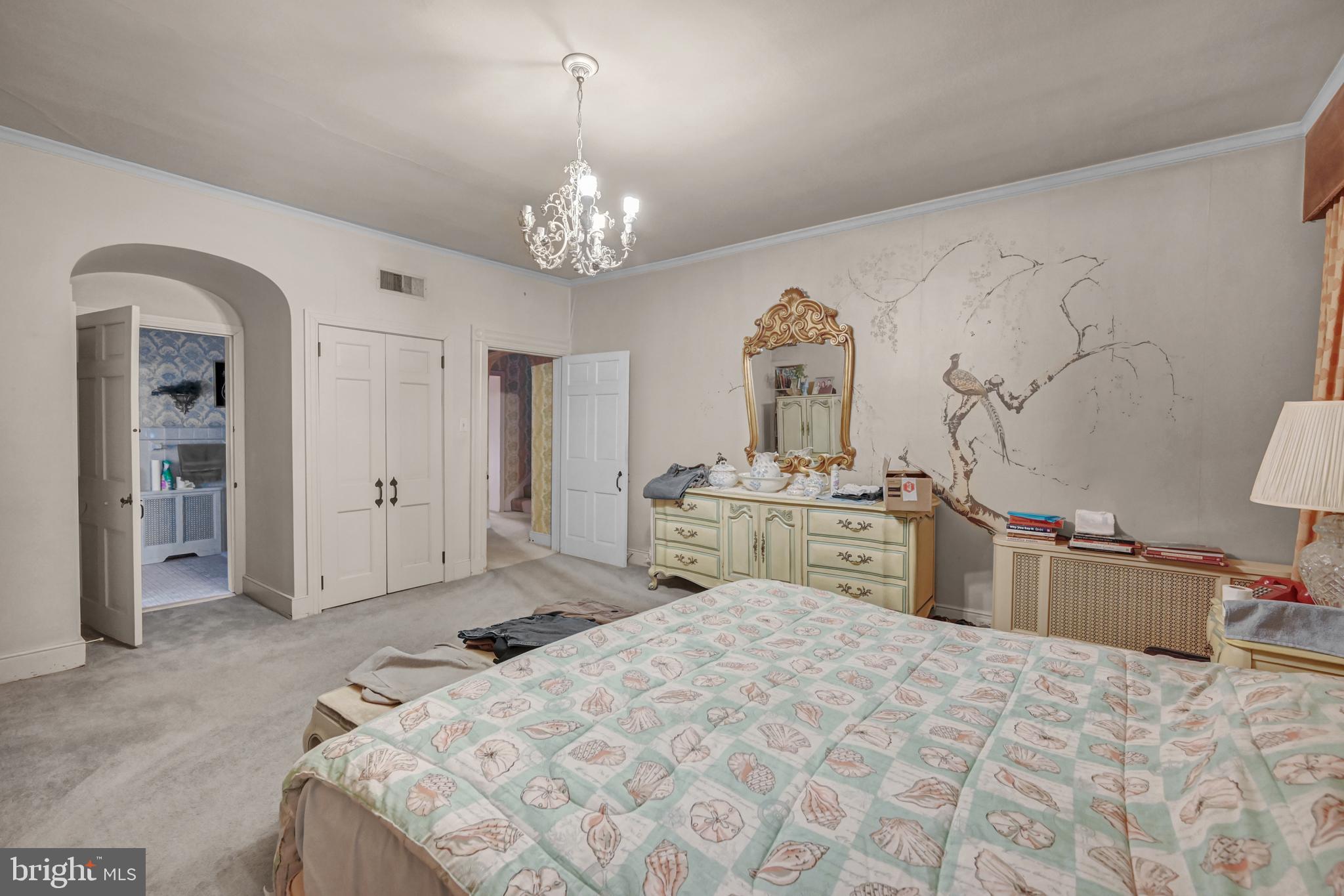 225 Moul Avenue Hanover, PA 17331 - Photo 28 of 81 a spacious bedroom with a large bed and a chandelier