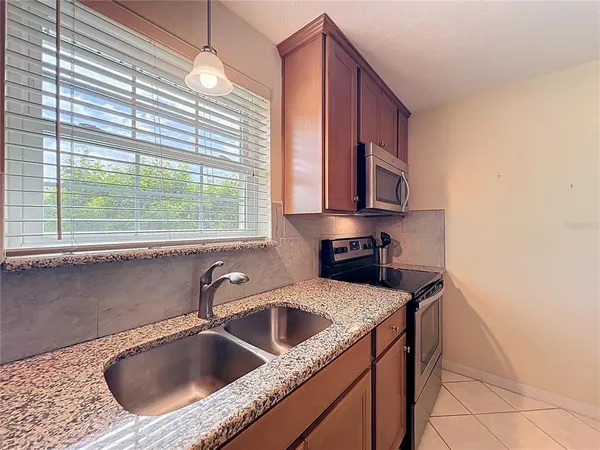 a kitchen with a stove a microwave and cabinets