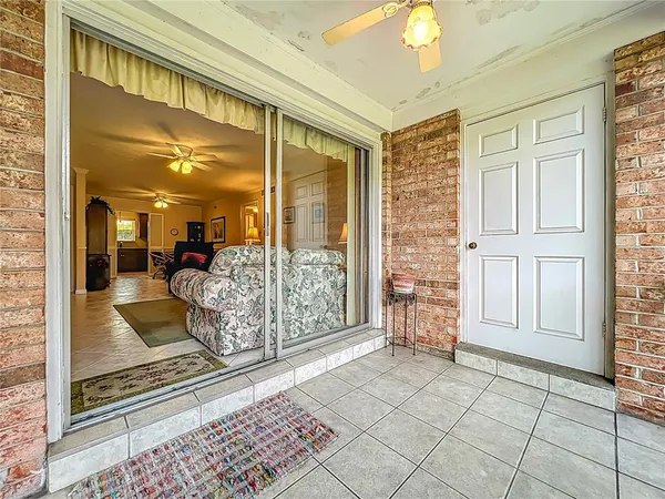 a view of a porch with wooden floor and iron stairs
