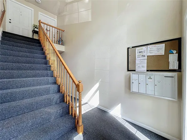 a view of a hallway with furniture and a potted plant