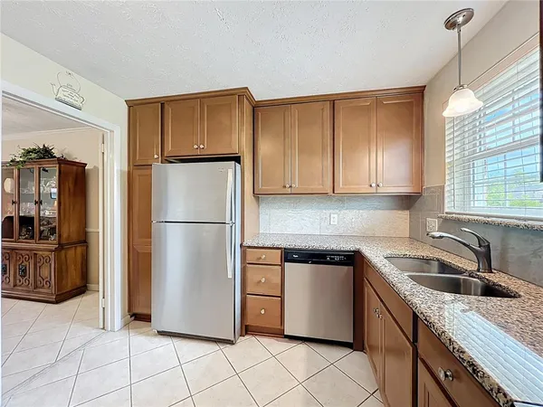 a kitchen with granite countertop cabinets stainless steel appliances and a sink