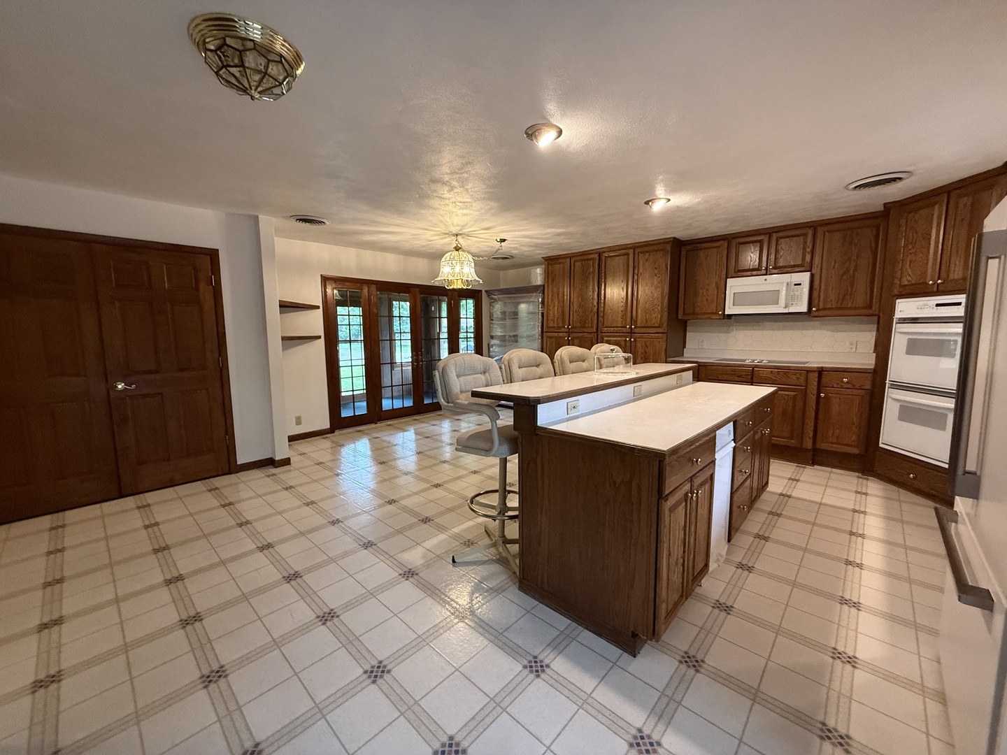 1048 Warren Street Henry, IL 61537 - Photo 12 of 26 a kitchen with stainless steel appliances granite countertop a stove a sink dishwasher and a refrigerator with wooden floor