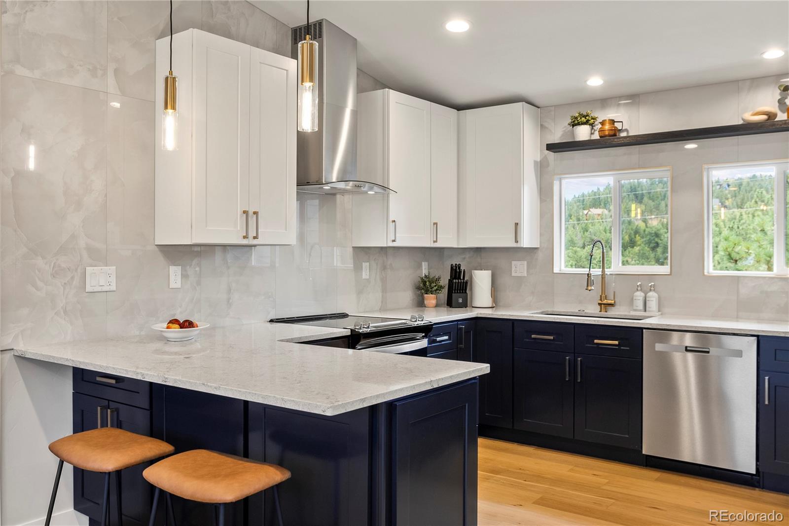 518 Conifer Drive Bailey, CO 80421 - Photo 12 of 50 a kitchen with stainless steel appliances granite countertop a sink and cabinets