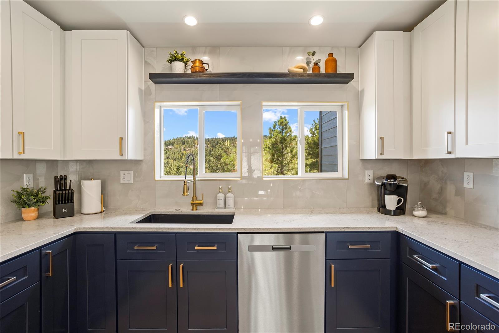 518 Conifer Drive Bailey, CO 80421 - Photo 14 of 50 a kitchen with stainless steel appliances a sink window and cabinets