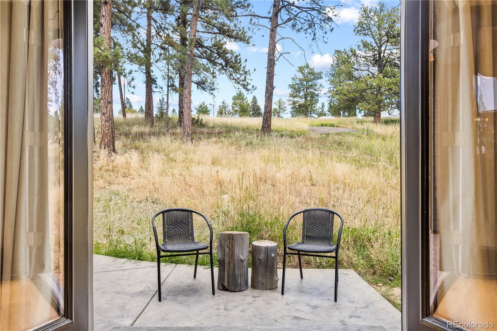 518 Conifer Drive Bailey, CO 80421 - Photo 26 of 50 a view of a balcony with chairs