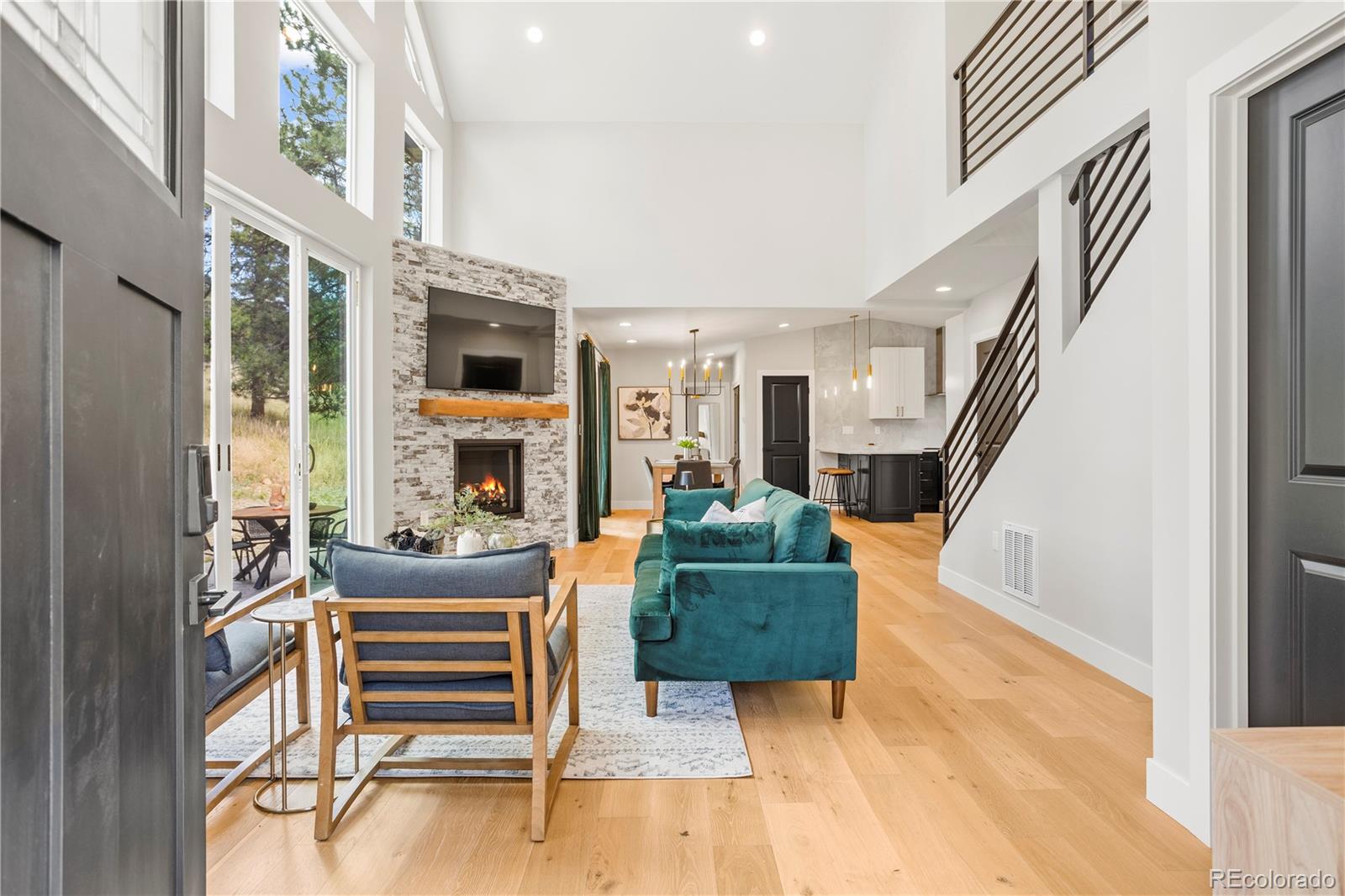 518 Conifer Drive Bailey, CO 80421 - Photo 30 of 50 a living room with furniture a fireplace and a large window
