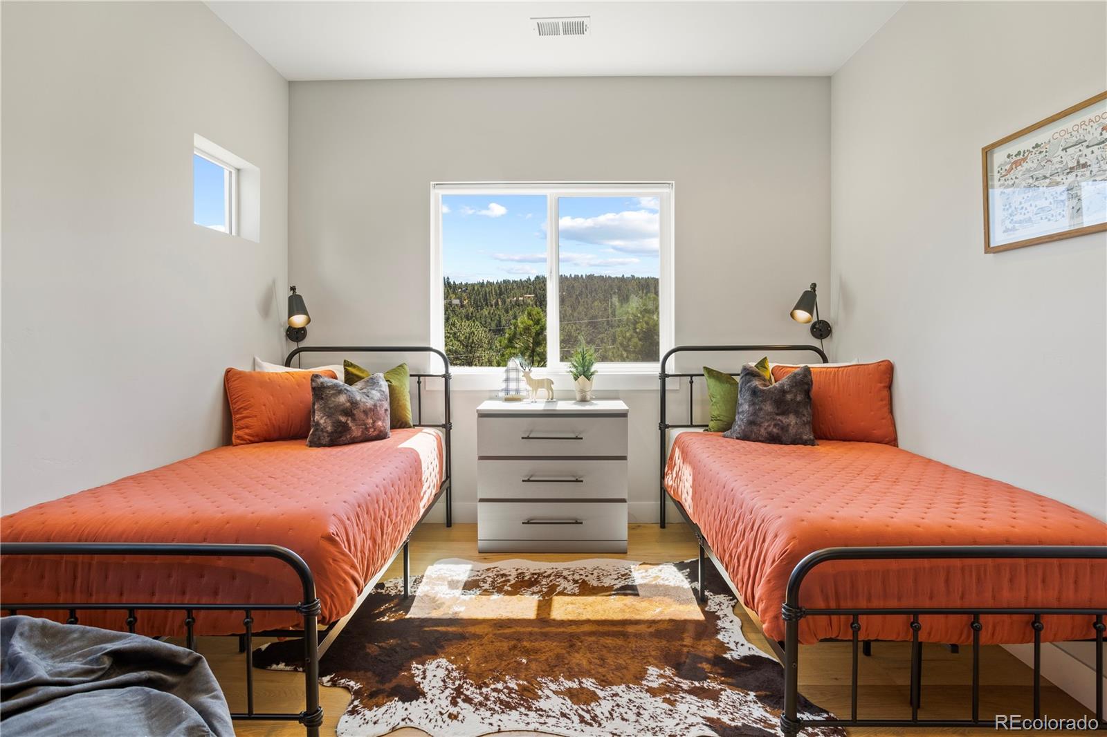 518 Conifer Drive Bailey, CO 80421 - Photo 36 of 50 a bedroom with a bed and wooden floor