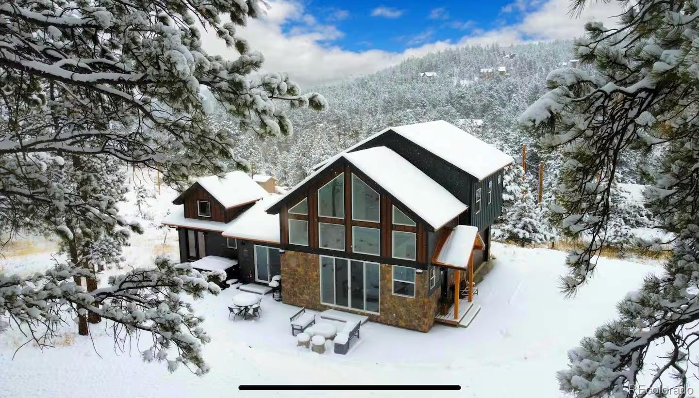518 Conifer Drive Bailey, CO 80421 - Photo 4 of 50 a view of a house with a snow in the background