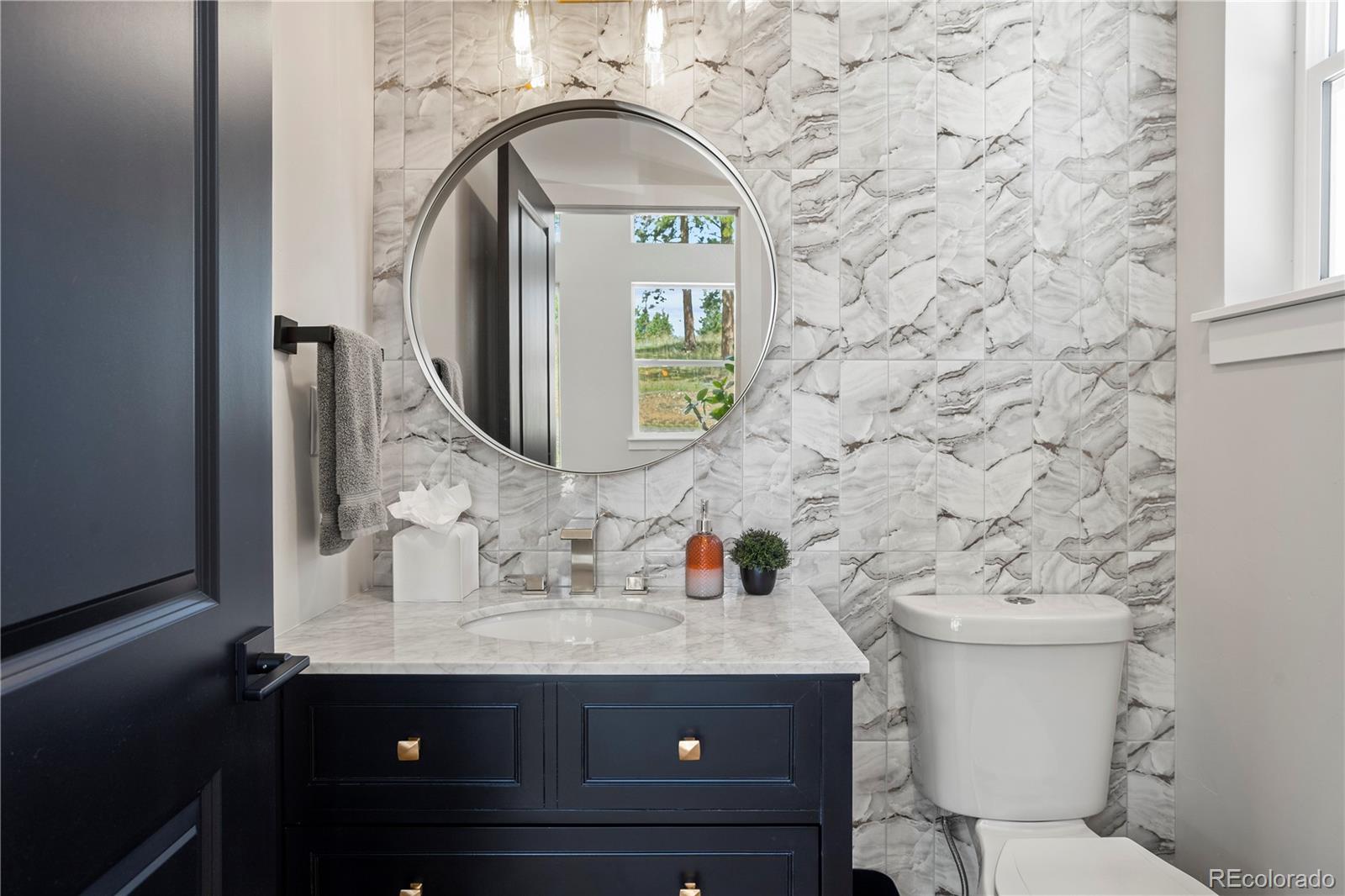 518 Conifer Drive Bailey, CO 80421 - Photo 7 of 50 a bathroom with a sink and a mirror