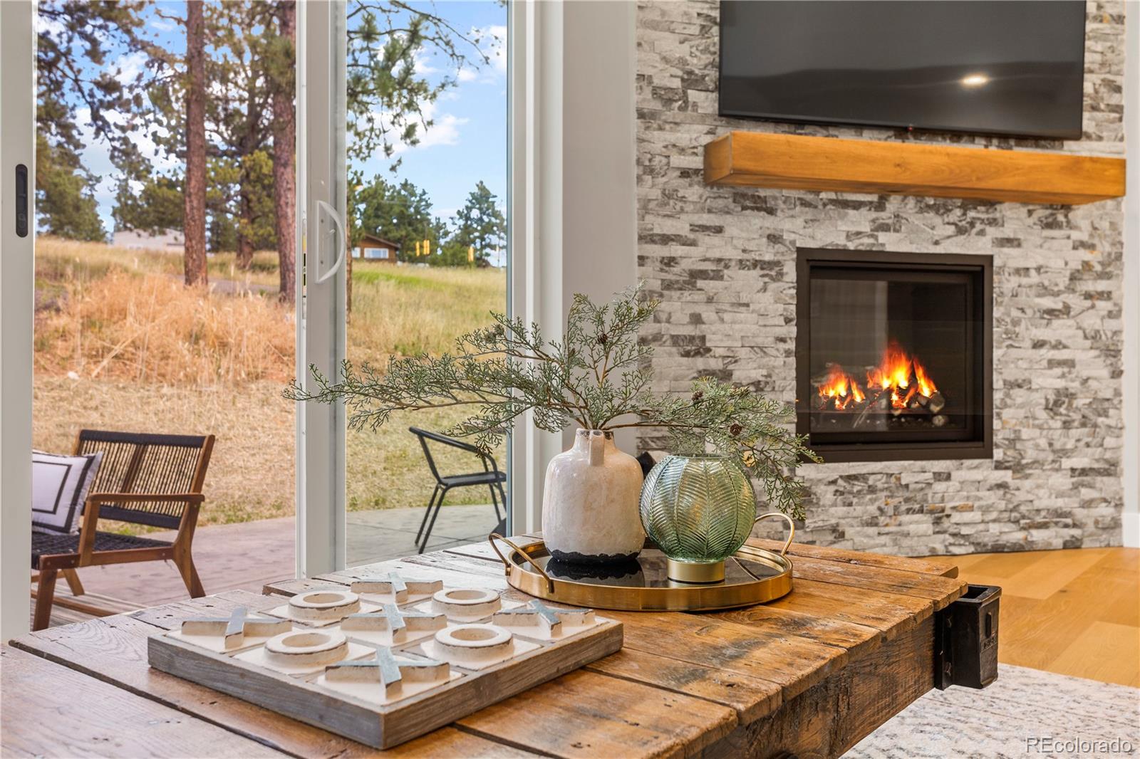 518 Conifer Drive Bailey, CO 80421 - Photo 10 of 50 a view of a kitchen with a stove and a fireplace
