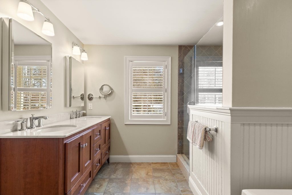 30 Underhill Road Lynnfield, MA 01940 - Photo 32 of 39 a bathroom with a double vanity sink a mirror and a bathtub