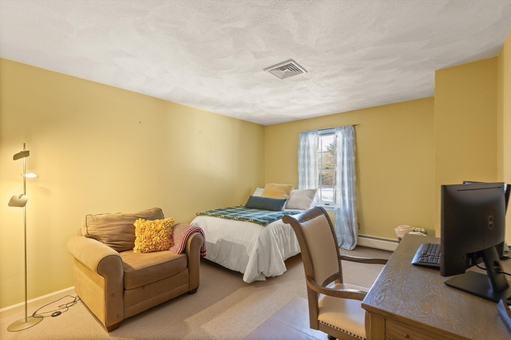 30 Underhill Road Lynnfield, MA 01940 - Photo 36 of 39 a bedroom with a bed and wooden floor