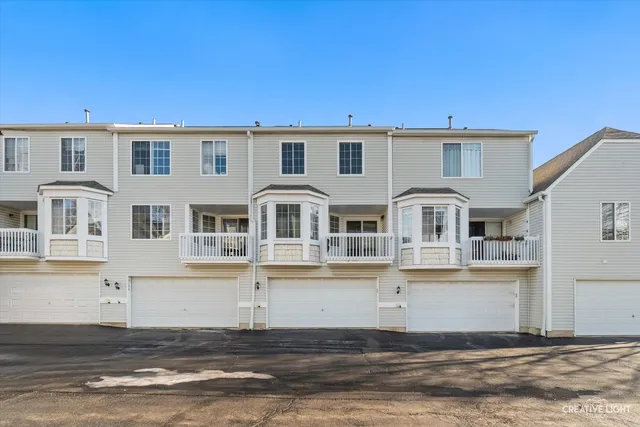a front view of residential houses with yard