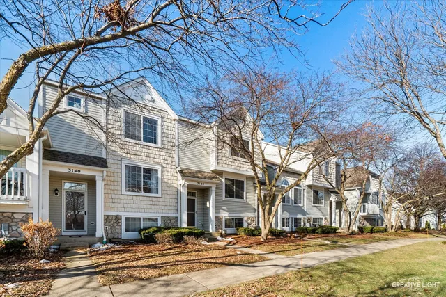 a front view of residential houses with yard