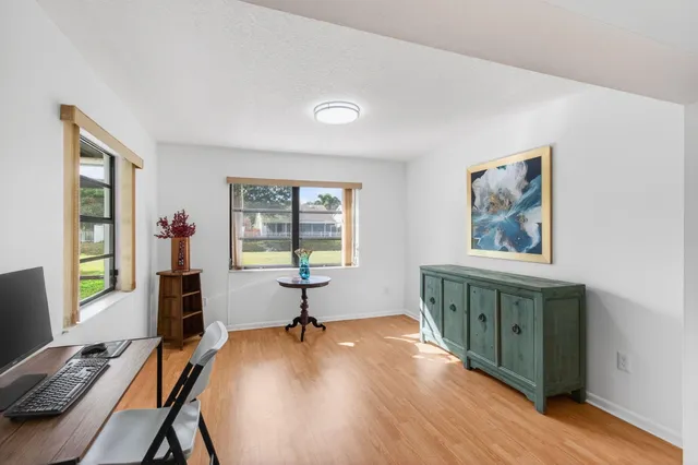 a en suite bathroom with a granite countertop sink and a mirror