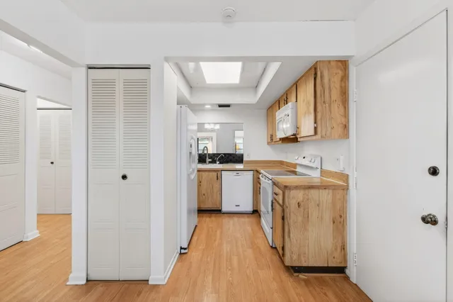 a front view of a house with a garden and yard