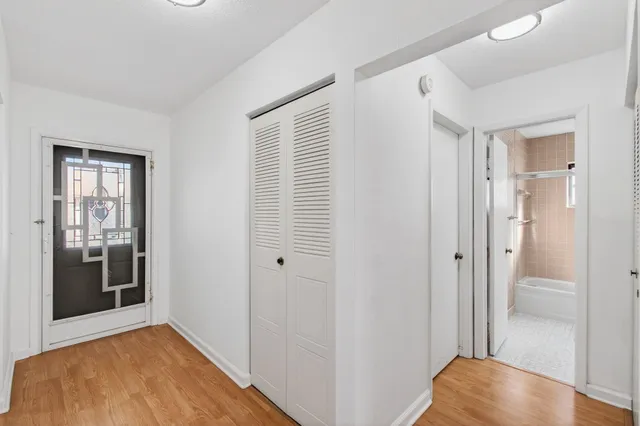 a living room with furniture and a large window with balcony view