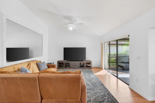 a view of a hallway with wooden floor and closet
