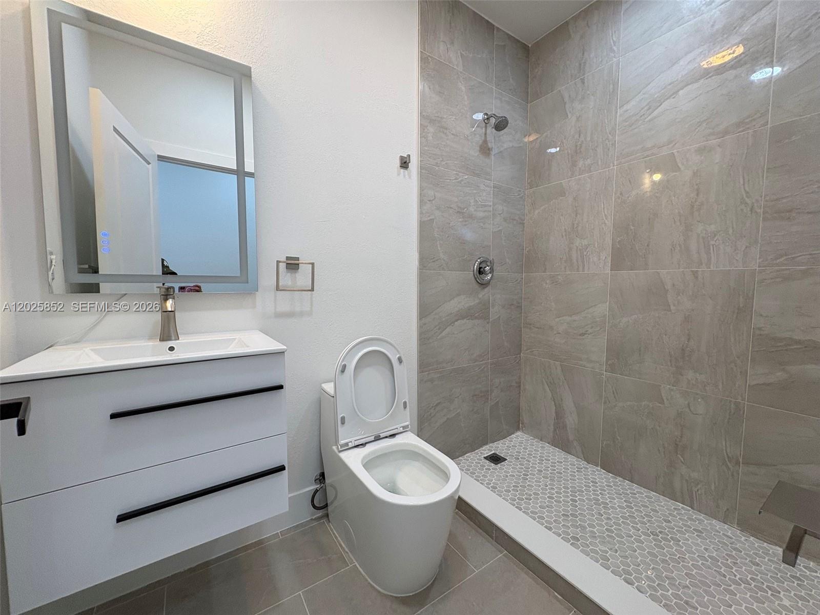 12948 Southwest 265th Terrace, Unit STUDIO Homestead, FL 33032 - Photo 16 of 16 a bathroom with a sink toilet and shower