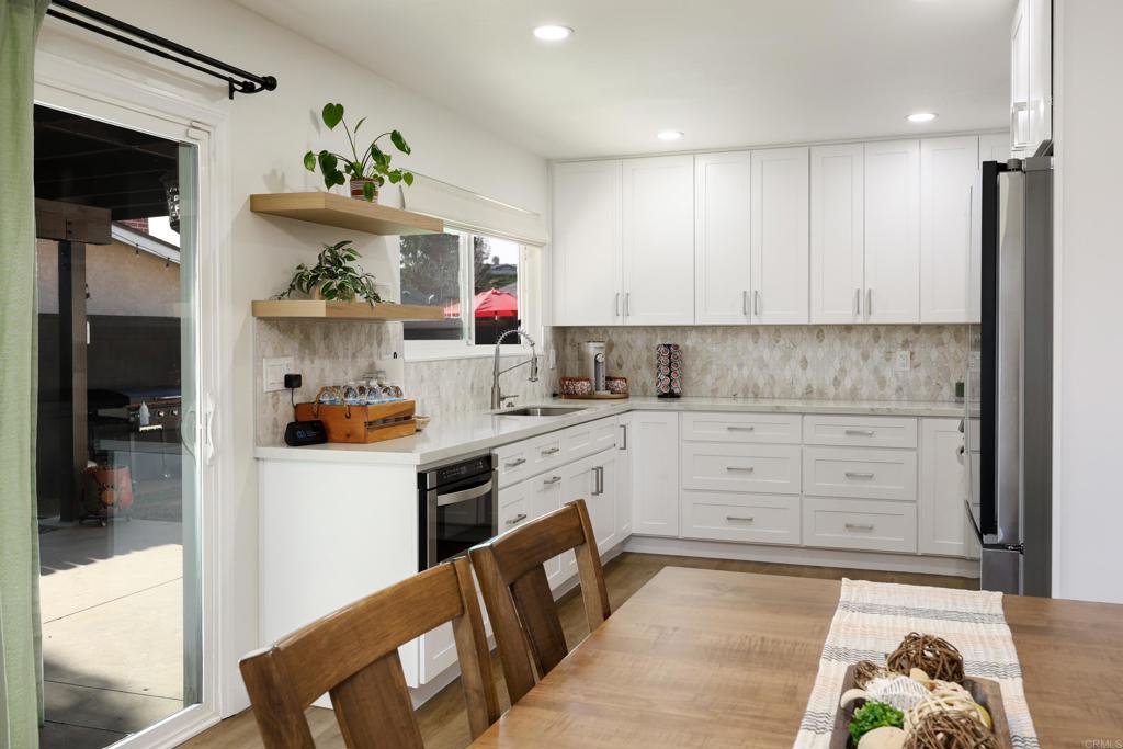 1024 Ransom Street San Diego, CA 92154 - Photo 13 of 41 a kitchen with white cabinets and appliances