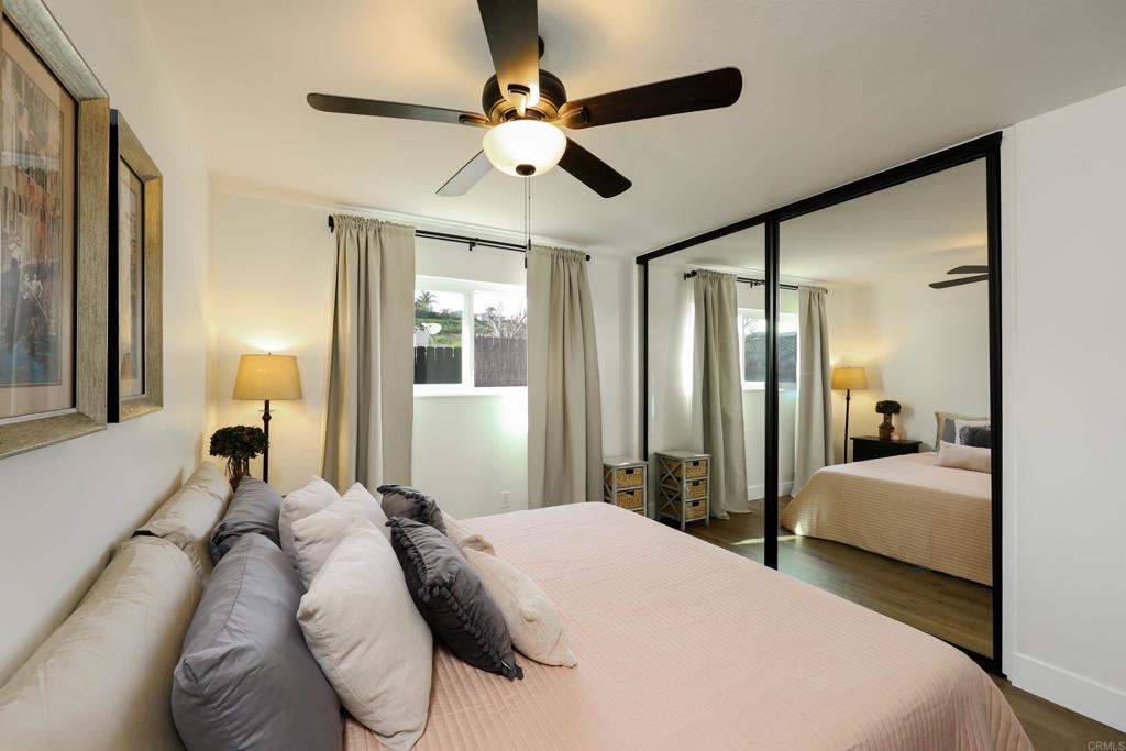 1024 Ransom Street San Diego, CA 92154 - Photo 22 of 41 a bedroom with a large bed and a chandelier