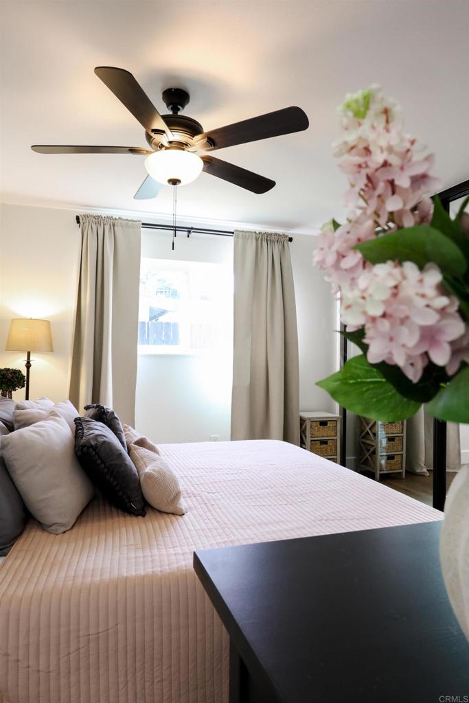 1024 Ransom Street San Diego, CA 92154 - Photo 23 of 41 a bedroom with a bed and a chandelier